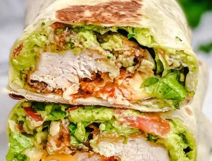 Delicious crispy chicken wrap with fresh vegetables and savory sauce