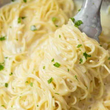 Delicious Garlic Parmesan Pasta garnished with parsley and served in a bowl