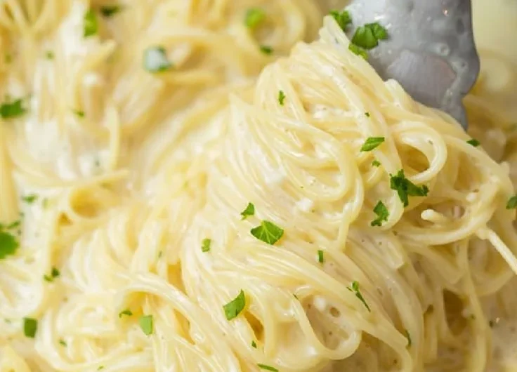 Delicious Garlic Parmesan Pasta garnished with parsley and served in a bowl