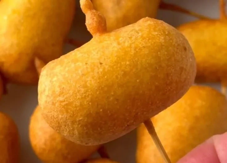 Plate of homemade mini corndogs with dipping sauce