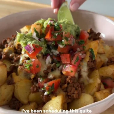 Delicious Loaded Potato Taco Bowl topped with fresh ingredients and served in a bowl