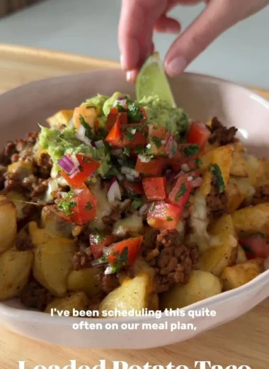 Delicious Loaded Potato Taco Bowl topped with fresh ingredients and served in a bowl