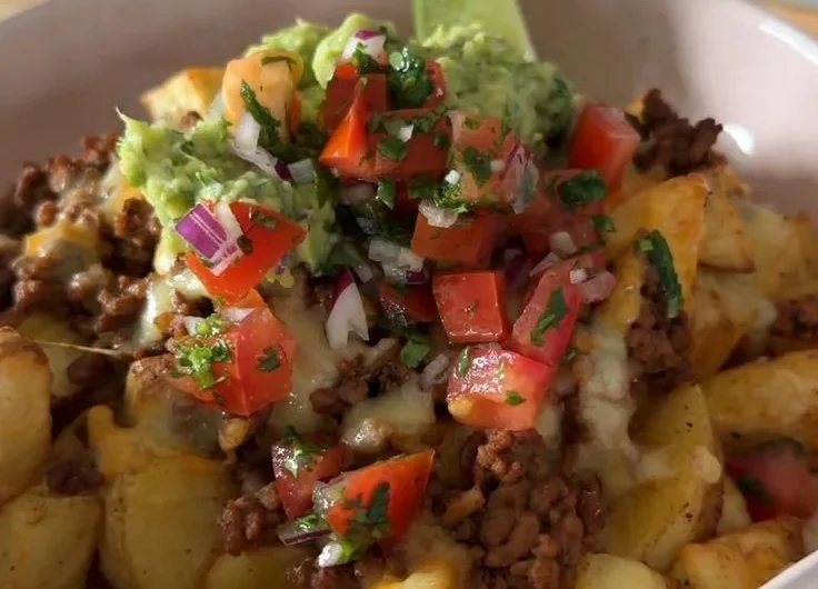 Delicious Loaded Potato Taco Bowl topped with fresh ingredients and served in a bowl