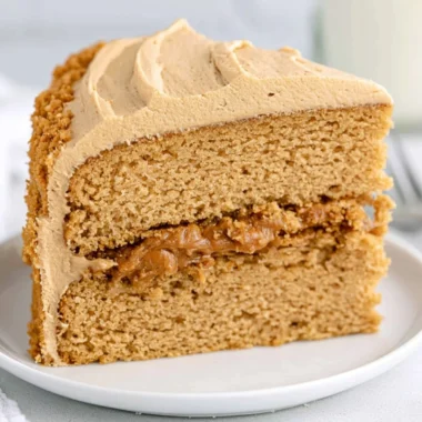 Delicious Biscoff Cake topped with creamy frosting and caramel drizzle.