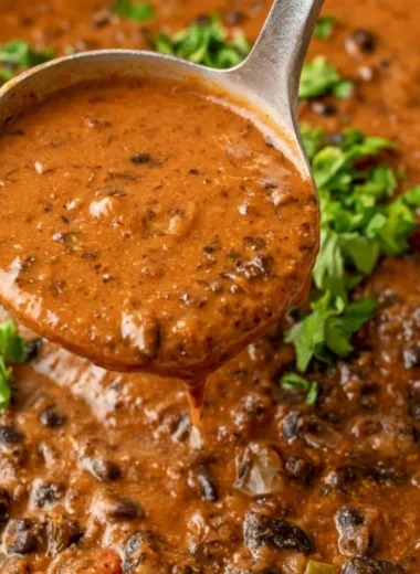 Delicious black bean soup served in a bowl with garnishes.