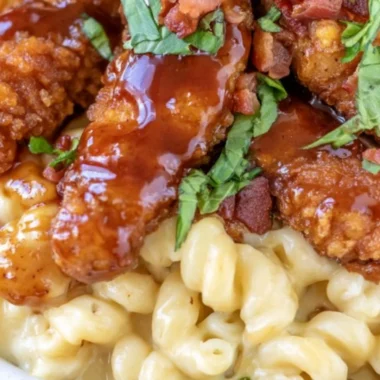 A delicious serving of Honey Pepper Mac and Cheese topped with spices and peppers.