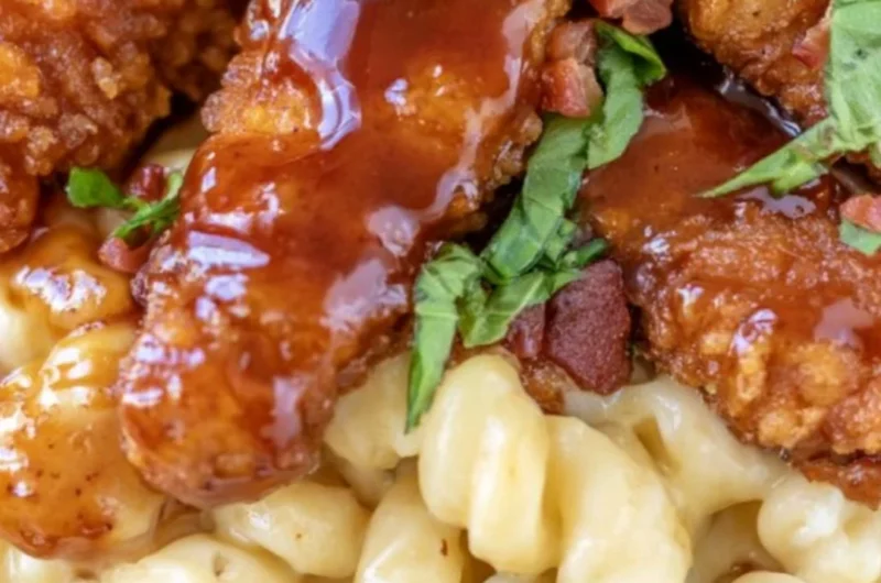 A delicious serving of Honey Pepper Mac and Cheese topped with spices and peppers.