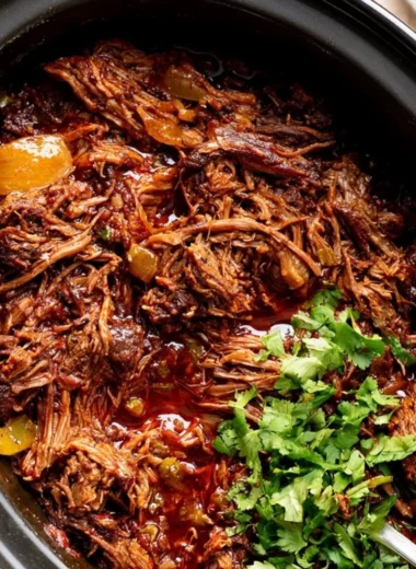 Delicious cozy beef barbacoa served with fresh toppings in a warm dish