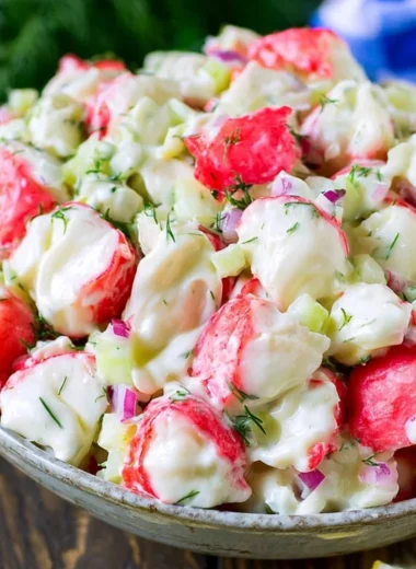 Delicious homemade crab salad served in a bowl with fresh ingredients.
