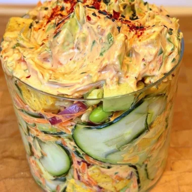 Creamy Asian cucumber salad with vegetables, sesame, and dressing served in a bowl