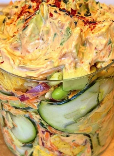 Creamy Asian cucumber salad with vegetables, sesame, and dressing served in a bowl