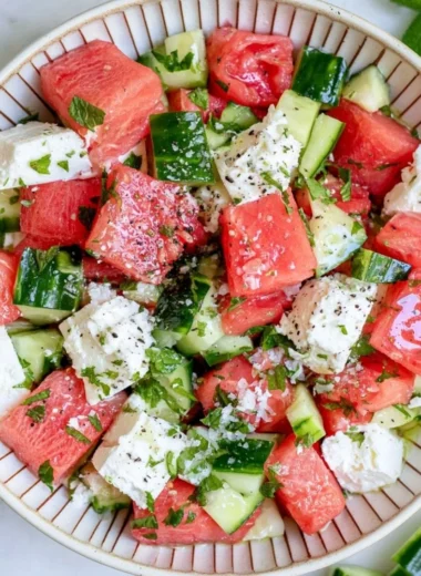Fresh watermelon cucumber salad with feta cheese served in a bowl