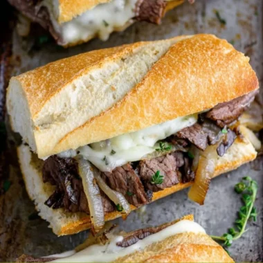A delicious steak sandwich with tender beef, fresh lettuce, and tomato on a toasted bun.