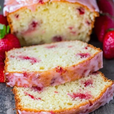 Delicious homemade strawberry pound cake slice on a plate with fresh strawberries
