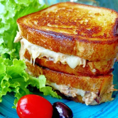 Delicious toasted tuna melt sandwich with cheese and fresh ingredients.