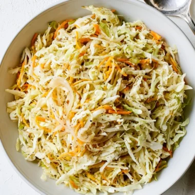 Bowl of fresh vinegar coleslaw with colorful cabbage and carrots