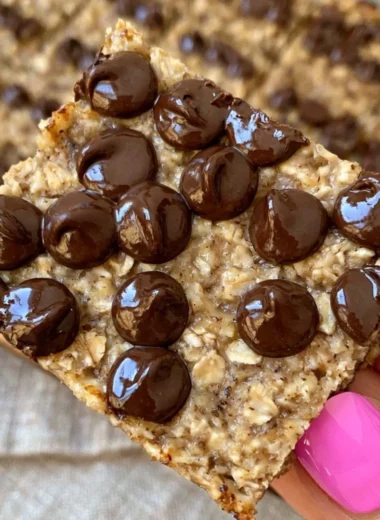 Delicious banana bread oatmeal bars topped with nuts and chocolate chips.