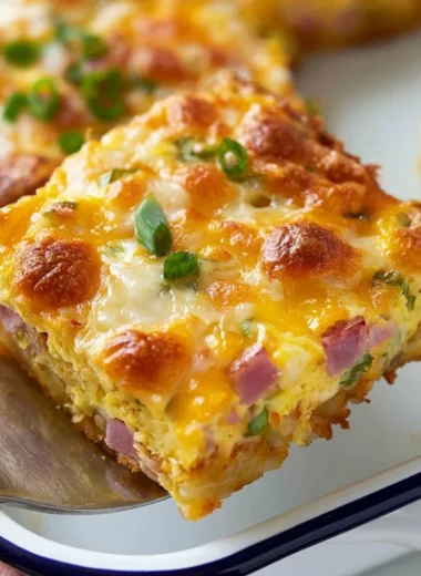 Savory breakfast casserole with hash browns, eggs, ham, and cheese baked to perfection.