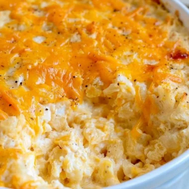 Delicious cheesy hashbrown casserole topped with melted cheese and crispy edges
