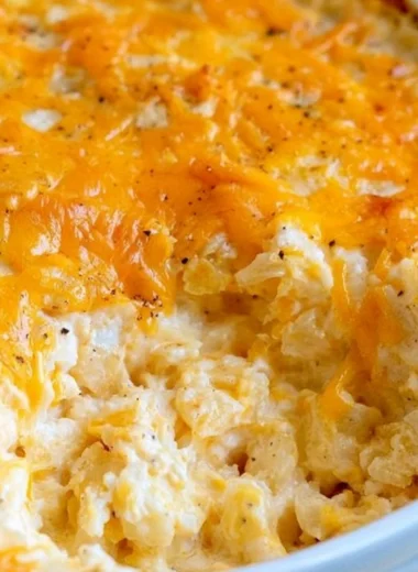 Delicious cheesy hashbrown casserole topped with melted cheese and crispy edges