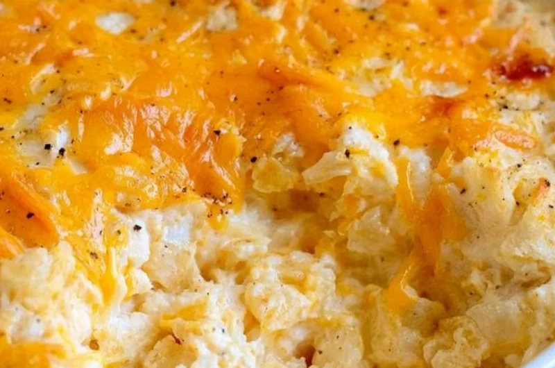 Delicious cheesy hashbrown casserole topped with melted cheese and crispy edges