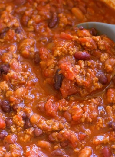 Bowl of healthy turkey chili garnished with fresh herbs and served with bread.