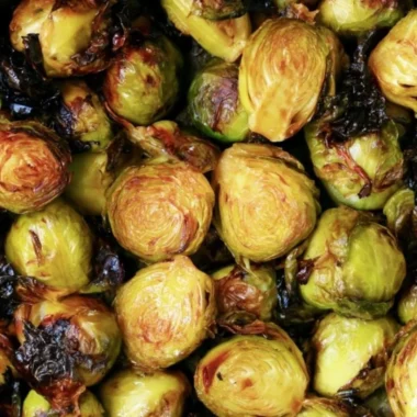 Cozy Brussels sprouts topped with balsamic glaze served in a bowl.