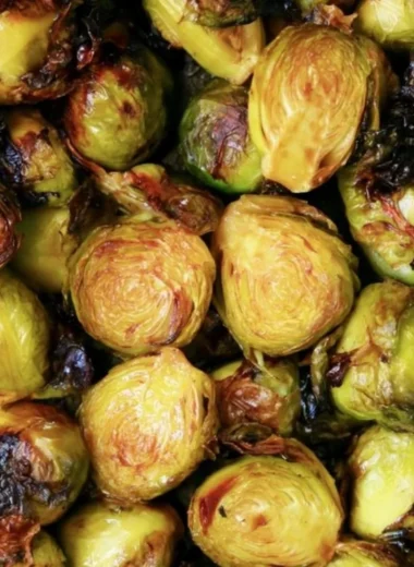 Cozy Brussels sprouts topped with balsamic glaze served in a bowl.