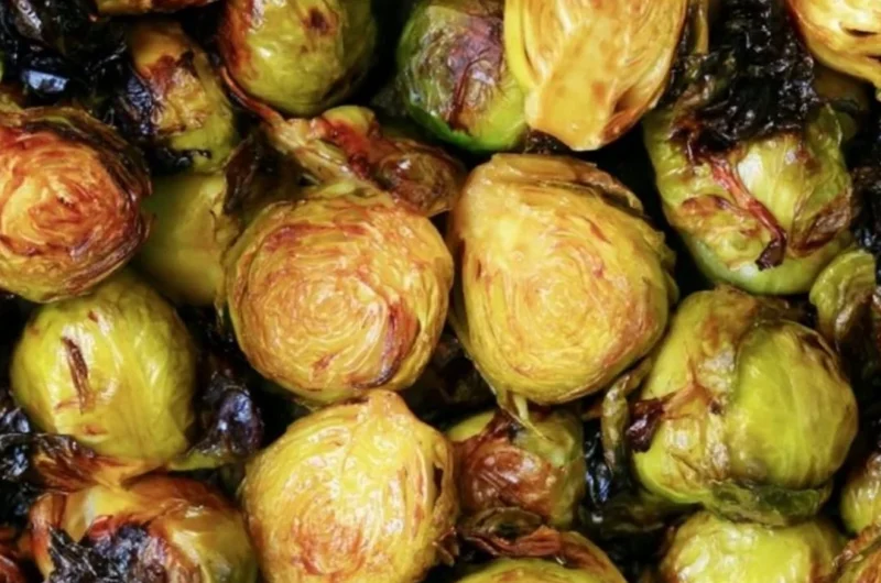 Cozy Brussels sprouts topped with balsamic glaze served in a bowl.