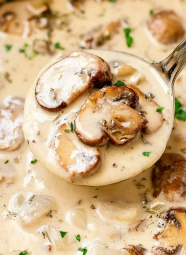 Bowl of cozy cream of mushroom soup garnished with herbs
