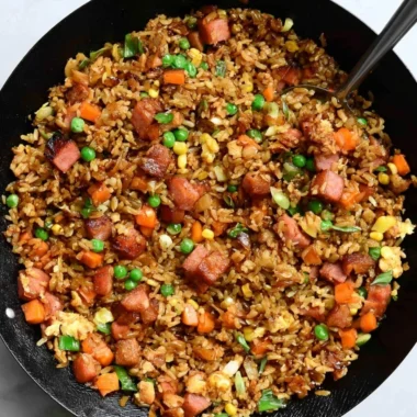 A bowl of cozy delicious Spam Fried Rice garnished with green onions.