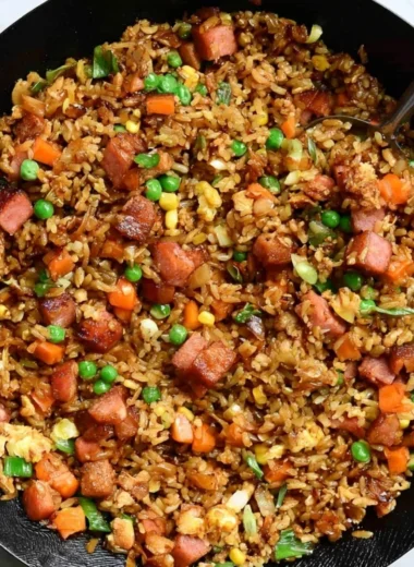 A bowl of cozy delicious Spam Fried Rice garnished with green onions.