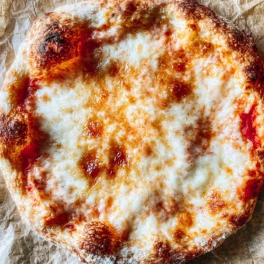 Cozy homemade pizza dough ready for baking with fresh ingredients.