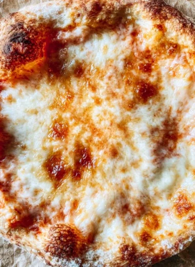 Cozy homemade pizza dough ready for baking with fresh ingredients.
