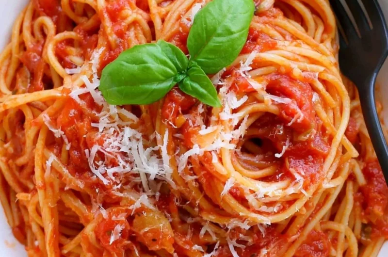 Cozy pasta tomato dish with vibrant red sauce and fresh herbs