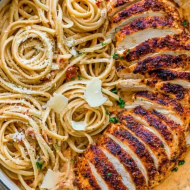 Delicious creamy Cajun chicken pasta served in a bowl with herbs