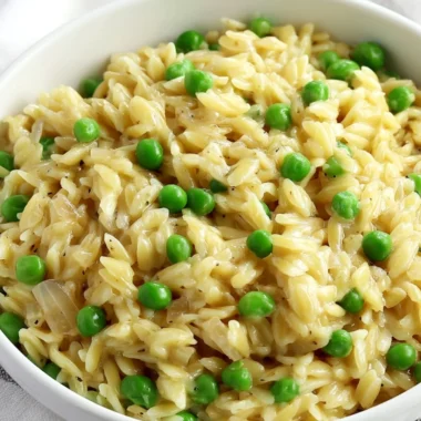 A bowl of creamy orzo delight garnished with herbs