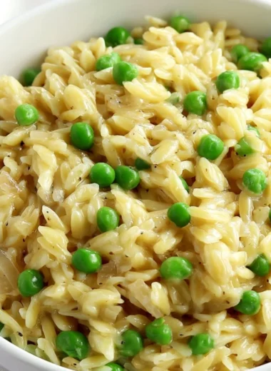 A bowl of creamy orzo delight garnished with herbs