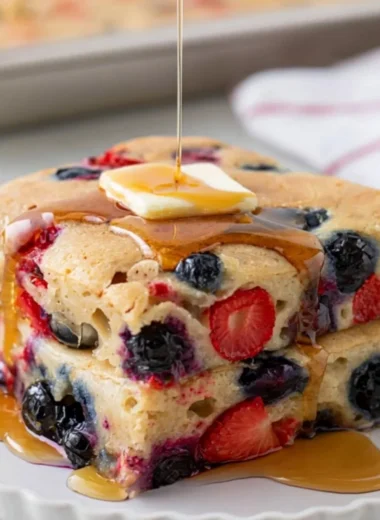 Delicious gluten free sheet pan pancake served with fresh berries and syrup
