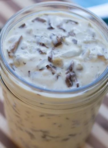 Bowl of homemade condensed cream of mushroom soup with fresh ingredients