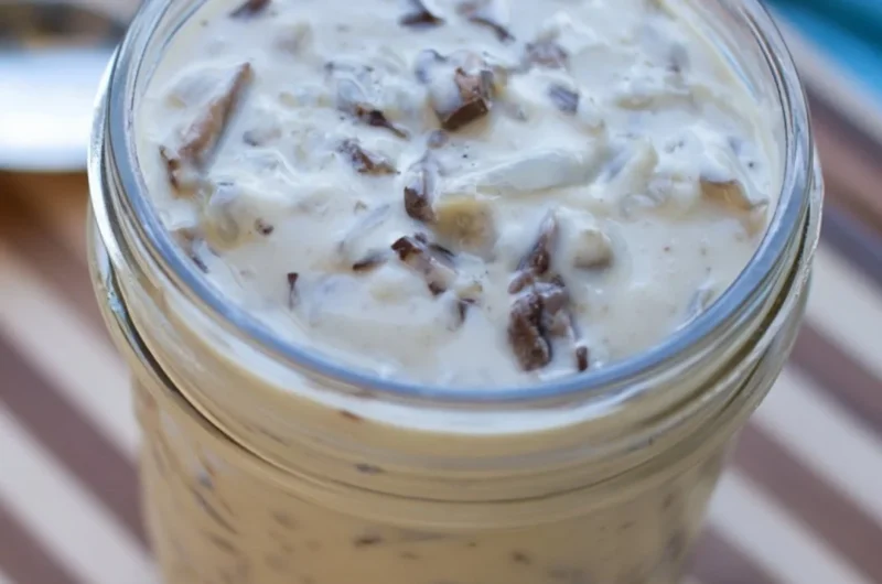 Bowl of homemade condensed cream of mushroom soup with fresh ingredients