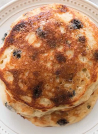 Delicious stack of sourdough pancakes topped with fresh berries and syrup