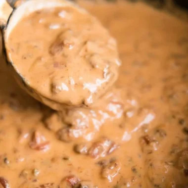 Creamy slow cooker queso dip served with tortilla chips