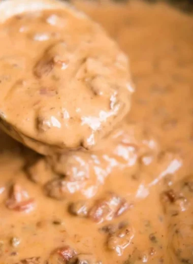 Creamy slow cooker queso dip served with tortilla chips