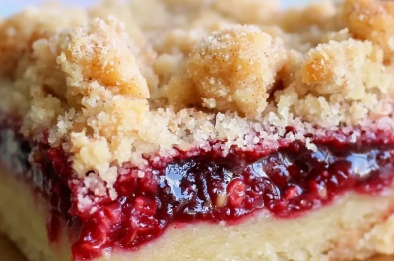 Delicious homemade Raspberry Crumb Bars with a golden crumb topping.