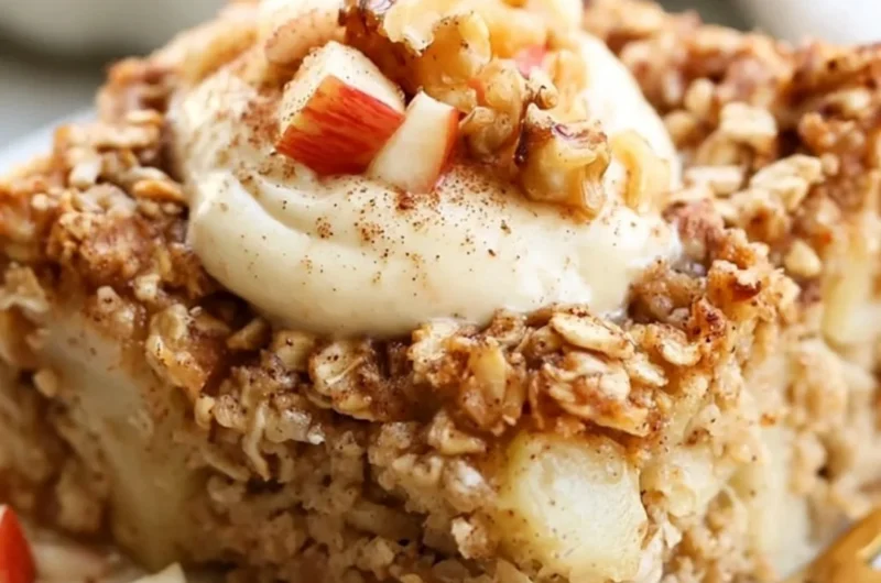Apple Baked Oatmeal with Cinnamon served in a bowl topped with fresh apple slices.