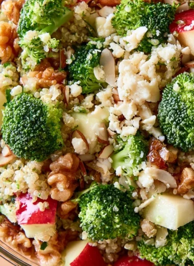 Fresh Broccoli Apple Quinoa Salad served in a bowl with colorful ingredients.