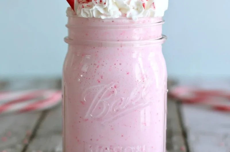 Delicious homemade candy cane milkshake topped with whipped cream and crushed candy canes