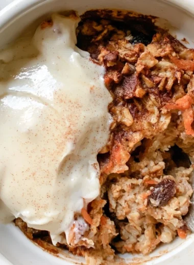 Delicious carrot cake baked oatmeal served in a bowl with frosting