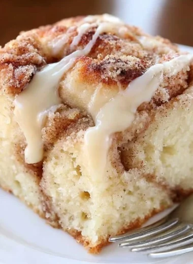 Delicious cinnamon roll coffee cake with cinnamon swirls and icing